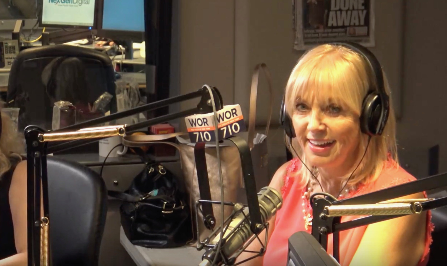 Blonde woman on-air at WOR 710 radio studio with headphones and mic.