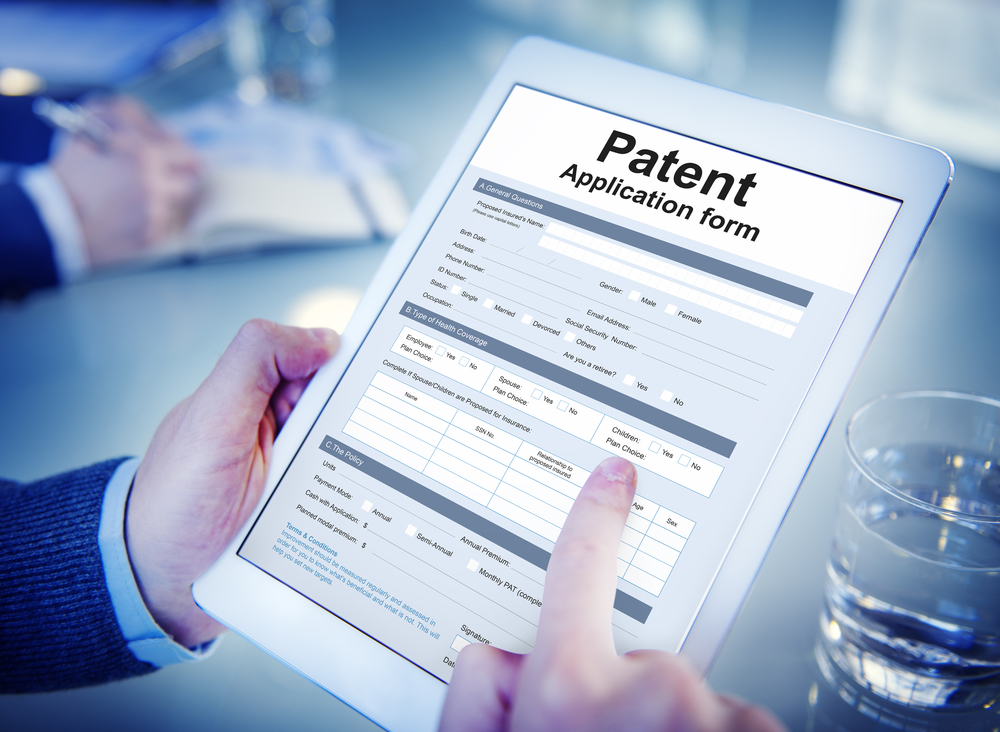 Man completing patent application form on ipad