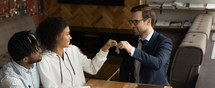 Lawyer handing business storefront keys to business owners