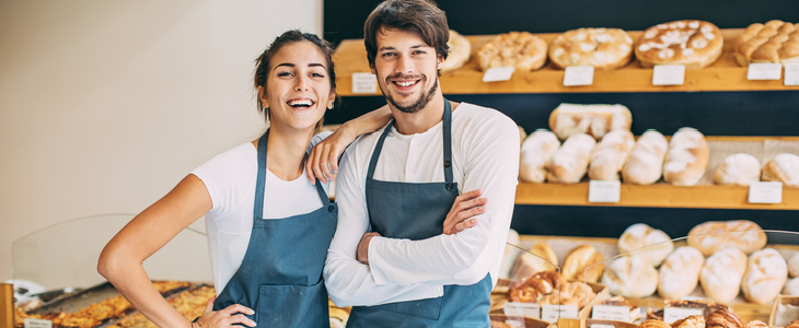 two bakery owners smiling