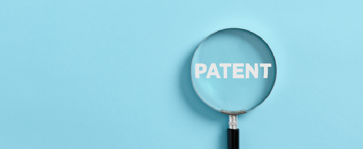 Magnifying glass pointing to the word PATENT