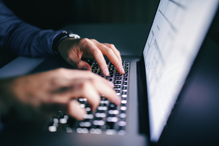 Man typing on his laptop