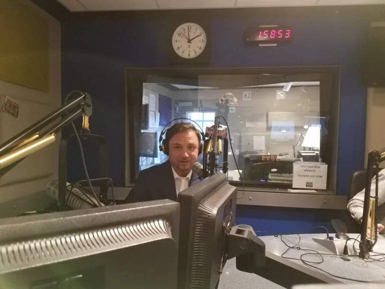 `Man speaking into microphone at WOR 710 radio studio`