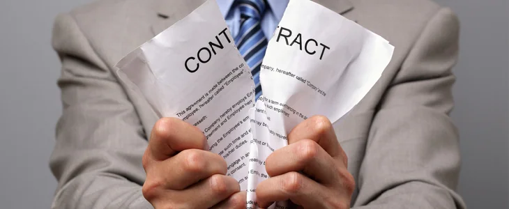 man ripping a contract in half