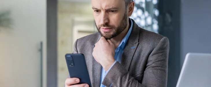 Business partner looking at his phone