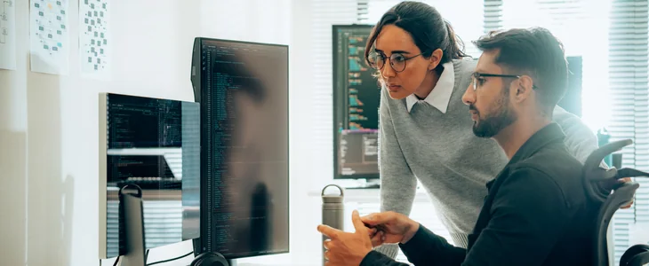 Engineers looking at a computer screen